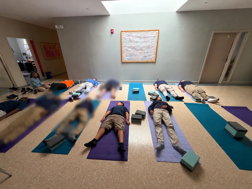 Students at High Road School of Anne Arundel County lie on yoga mats during a guided Friday yoga and relaxation session.