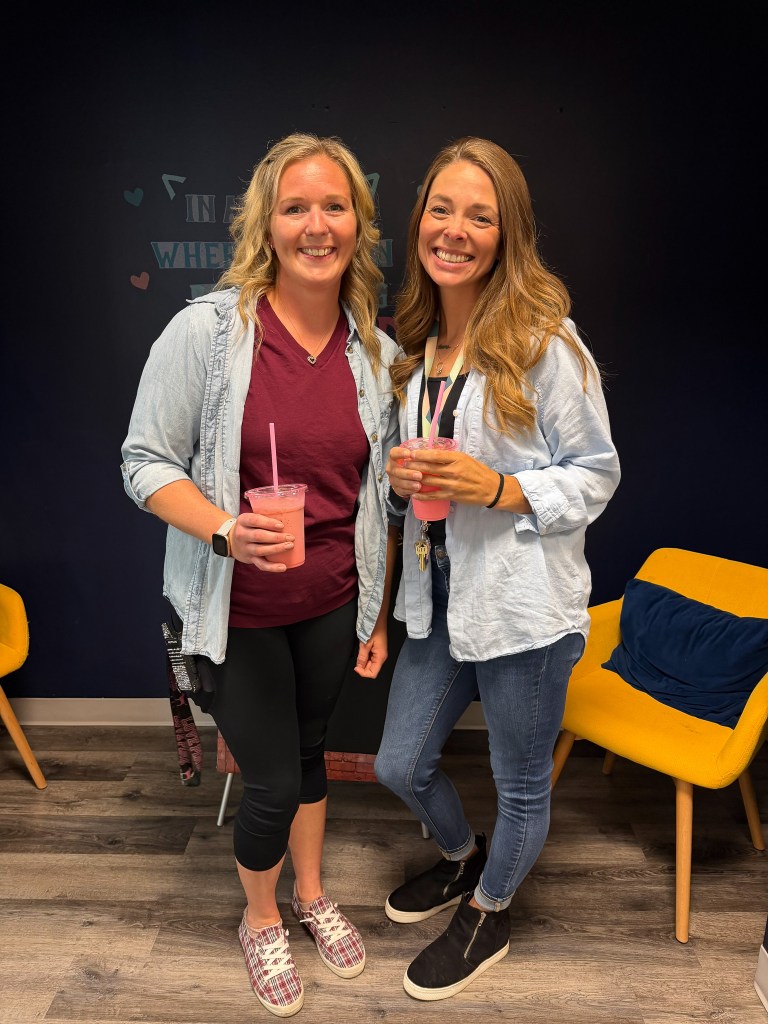 Two High Road School of Wright City staff members holding pink drinks during the Friday Pick-Me-Up Cart.