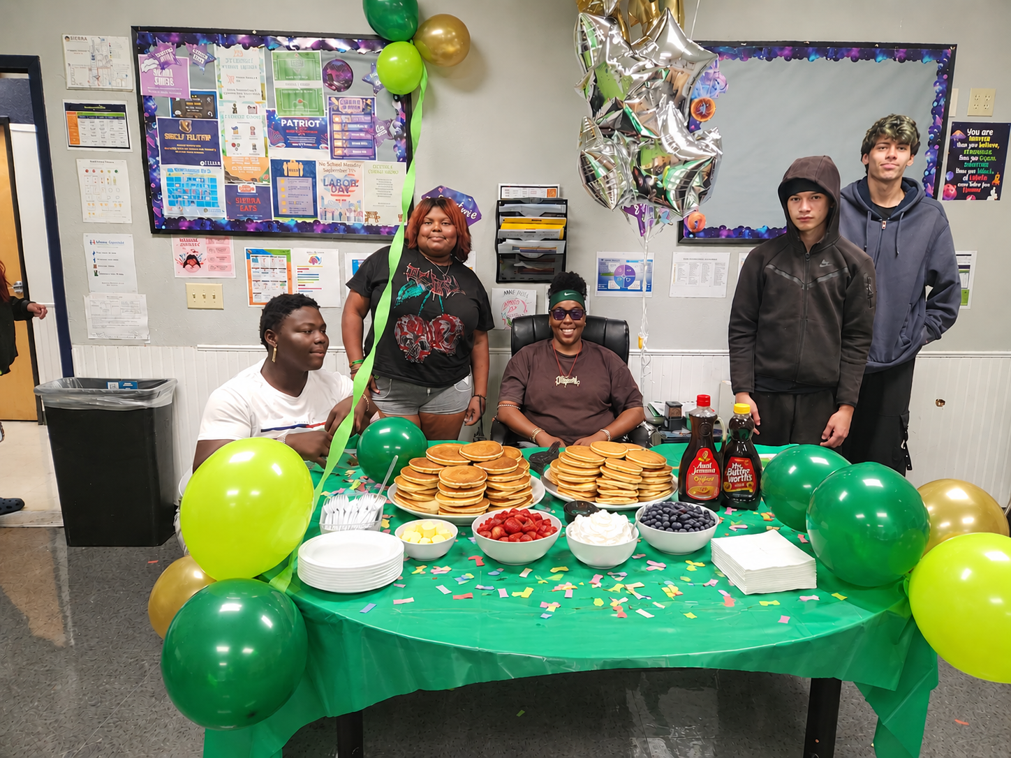 Sierra School of Sacramento students gathered around a pancake breakfast table during a student success celebration.