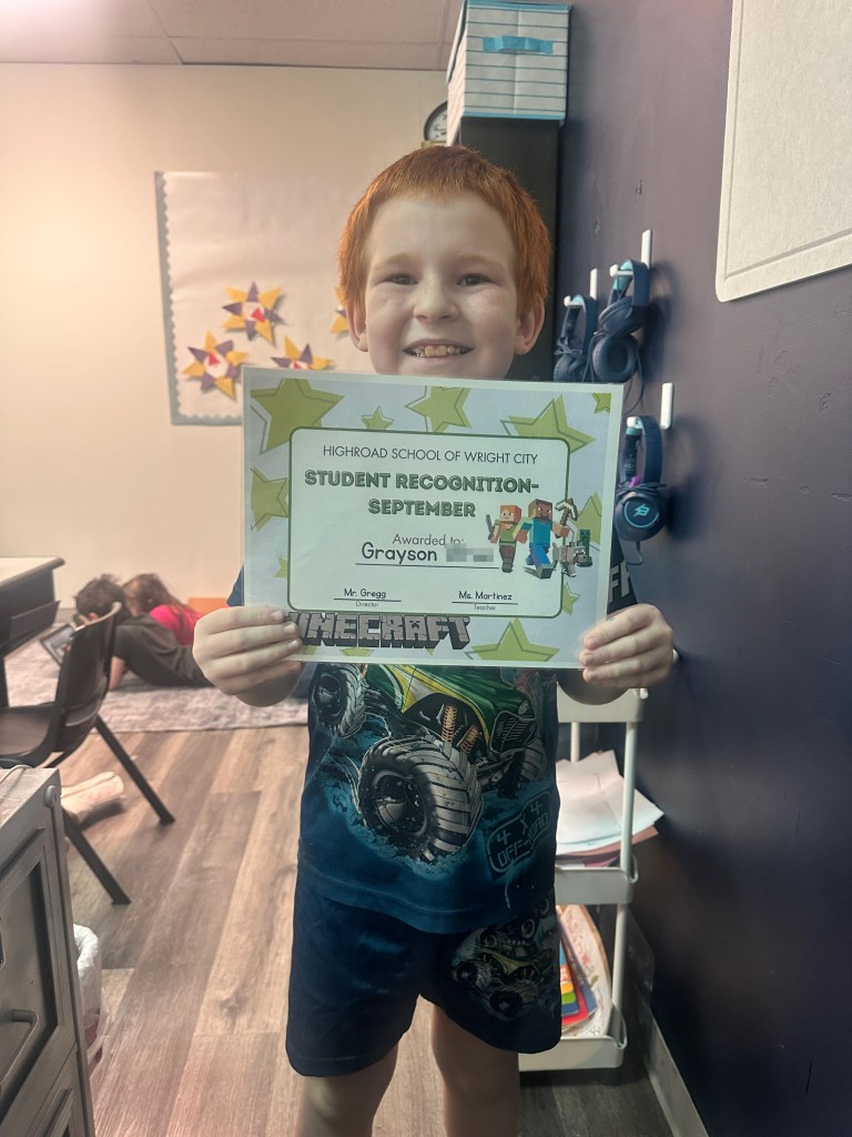 Grayson Wren holds his student recognition certificate at High Road School of Wright City.