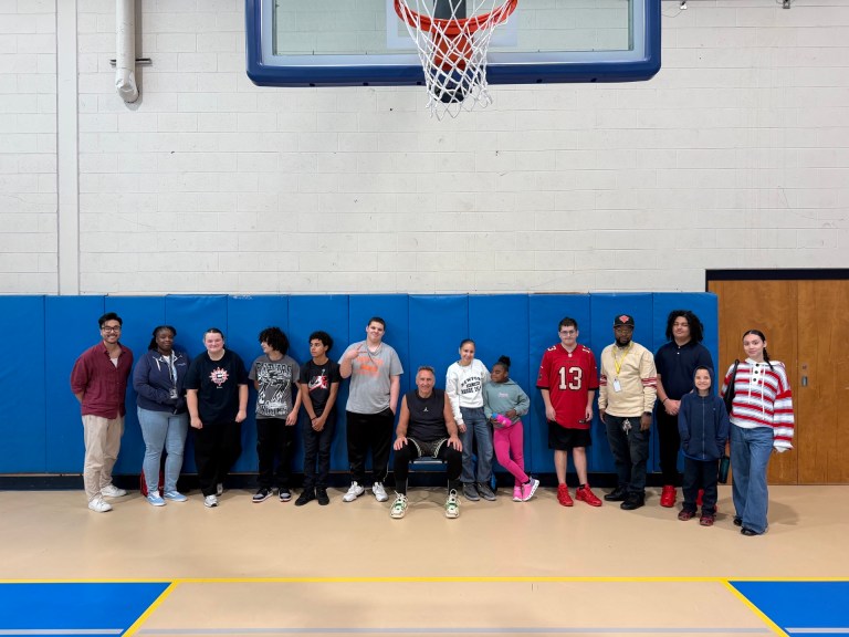 Students and staff from the High Road Schools of Hartford pose for a group photo with basketball coach Dave Hopla after the shooting clinic.