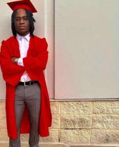 Quisean Suters-Robinson holding his diploma