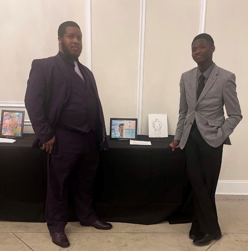 Student Joseph (right) pictured with his artwork and guest.
