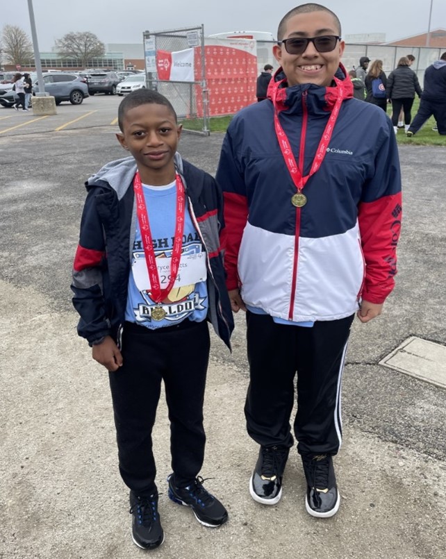 Bryce Watts and Diego Torres wearing 1st Place Gold Medals for the 100 Meter Dash
